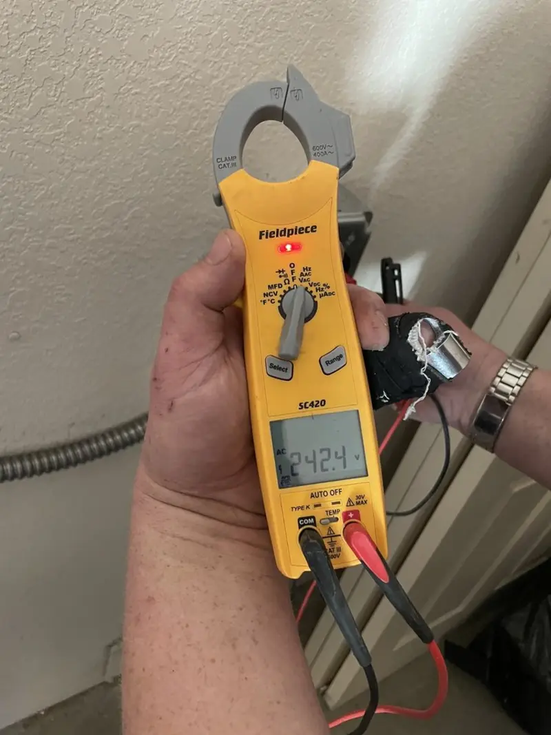 Voltage testing with clamp meter during Electrical Installation Services in Albert Lea